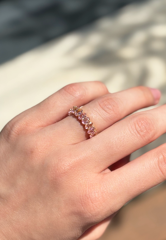 pink zirconia stone ring on a hand with soft sunlight