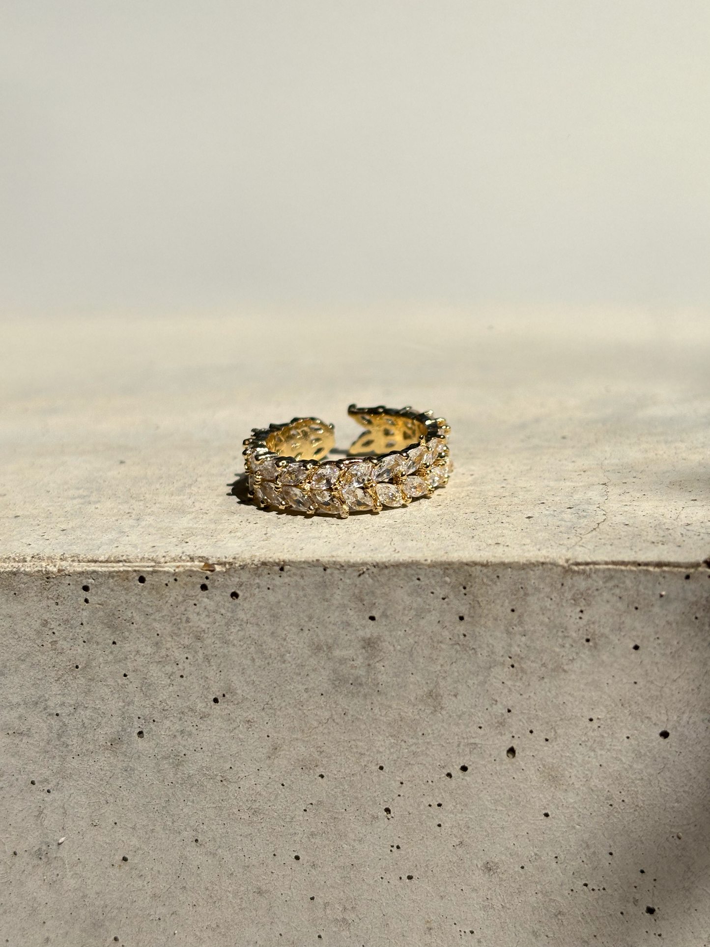 clear zirconia stone ring on a concrete plate with soft sunlight