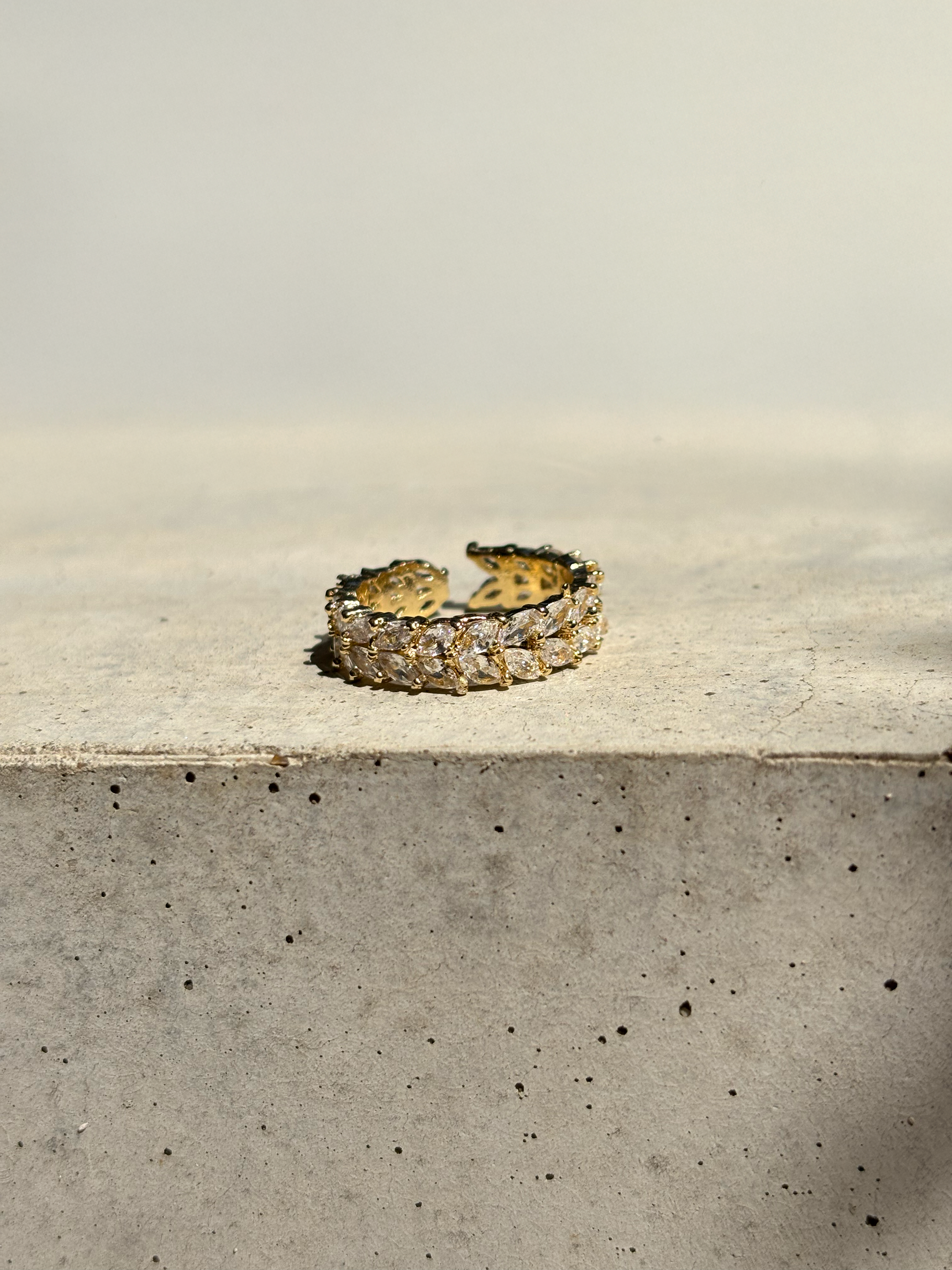 clear zirconia stone ring on a concrete plate with soft sunlight