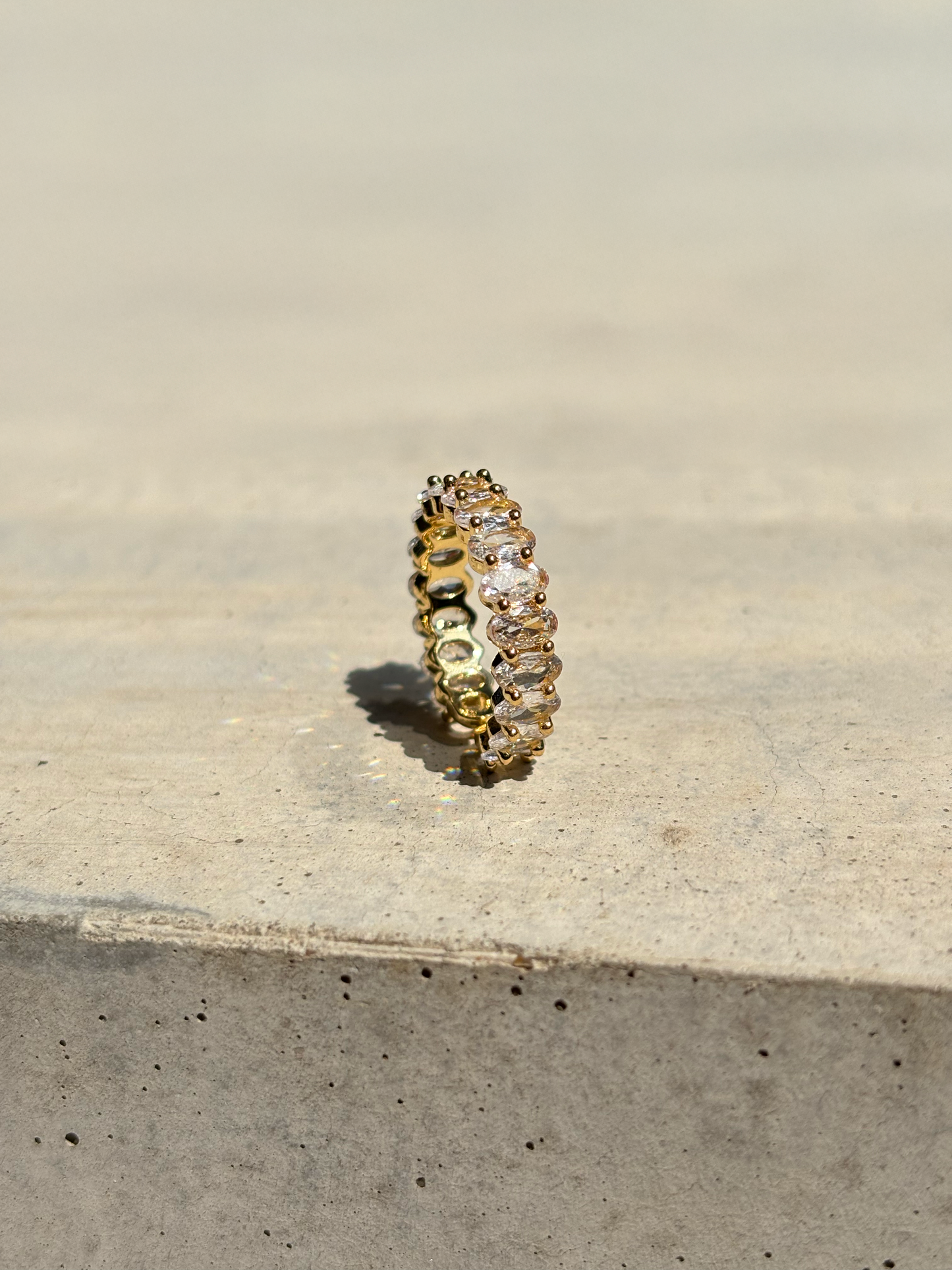clear zirconia stone ring on a concrete plate with soft sunlight