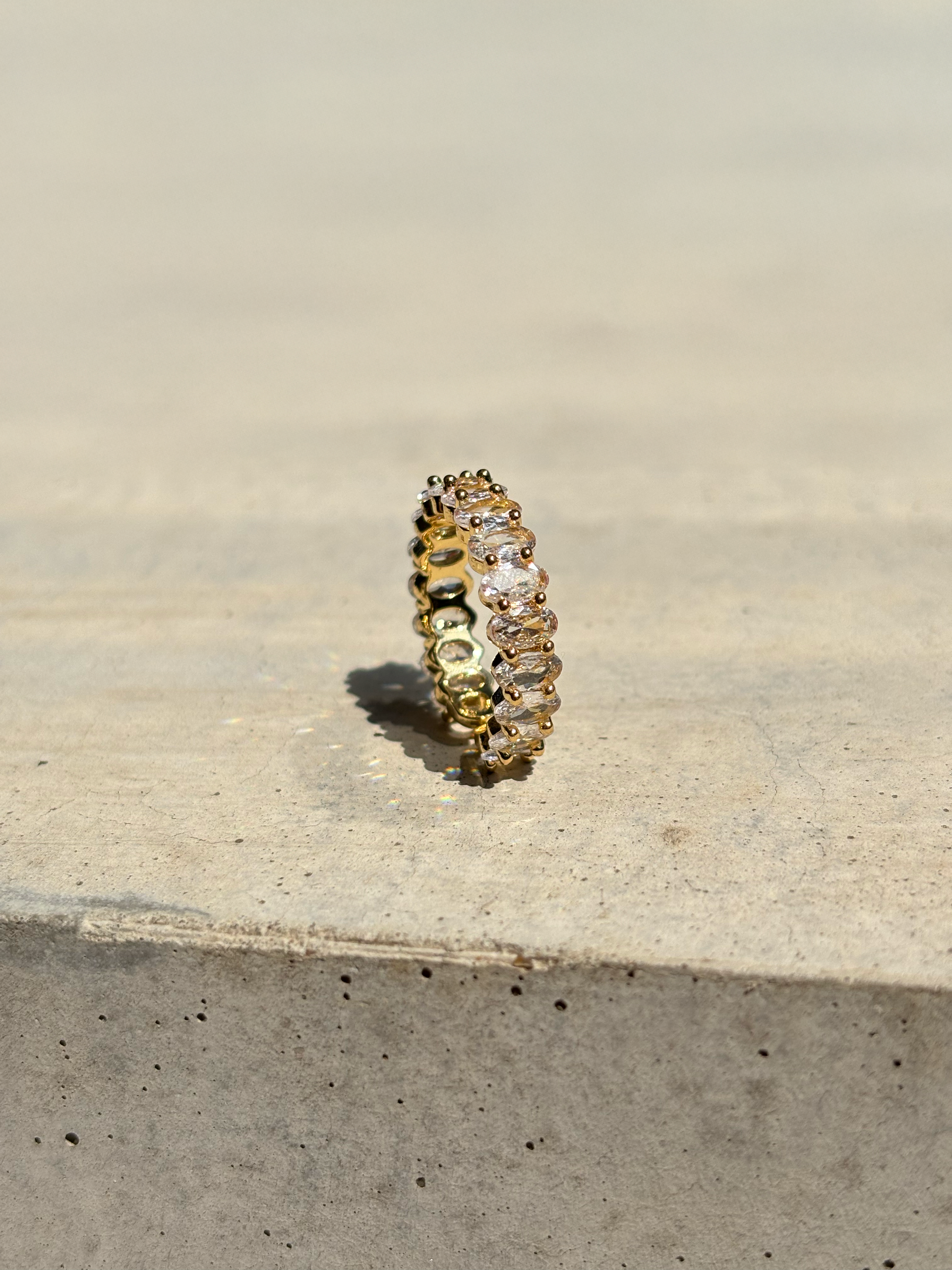 clear zirconia stone ring on a concrete plate with soft sunlight