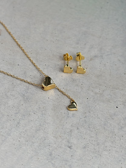 golden heart-shaped necklace and heart-shaped earrings
